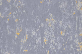 Antique Gold metallic flexible wall panel – cool blue-grey base with irregular scattered gold flake patches creating aged antique gold foil effect, flat lay close-up