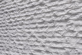 Axecarved white flexible stone panel – horizontal layered texture, angled close-up view