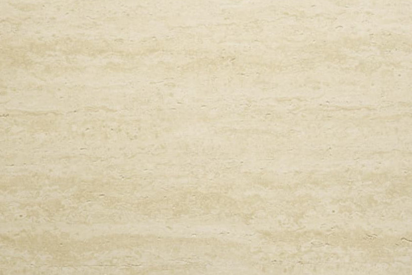 Giallo Antico travertine flexible stone panel – soft cream-white surface with delicate horizontal flowing grain and fine natural texture, flat lay close-up