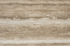 Earthy Stratum travertine flexible stone panel – Moka Walnut variant, flat lay close-up showing cool grey-brown surface with bold horizontal earthy layering and natural pitted texture
