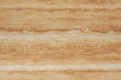  Earthy Stratum travertine flexible stone panel – Ochre Earth variant, flat lay close-up showing deep warm ochre-brown surface with bold horizontal earthy layering and rustic pitted texture