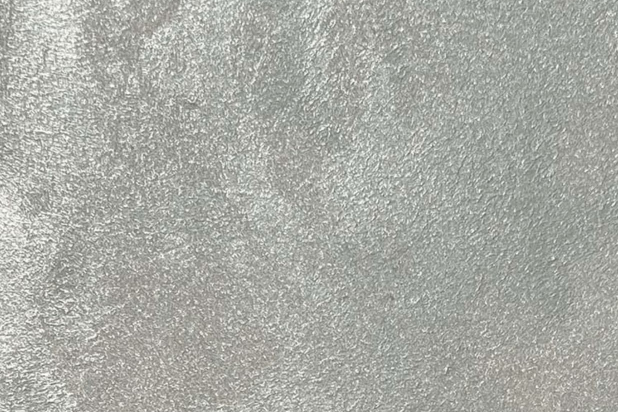 Satin Platinum metallic flexible wall panel – cool silver surface covered in fine hammered foil texture with subtle iridescent shimmer, flat lay close-up