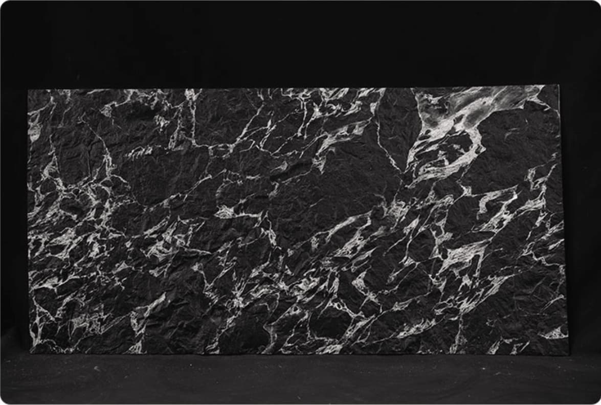 Veined Black Basalt flexible stone panel – full sheet front view showing dense silver-white fractured vein pattern across deep black three-dimensional surface on dark background
