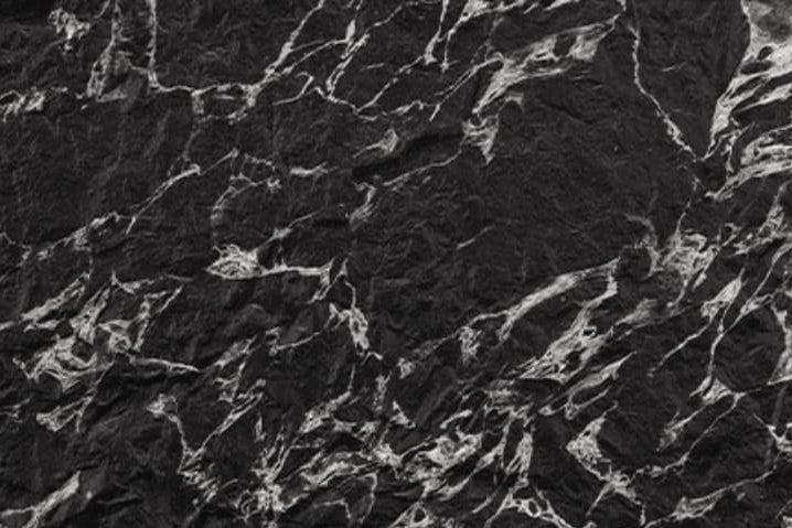 Veined Black Basalt flexible stone panel – dramatic deep black surface with dense silver-white fractured vein network and bold three-dimensional texture, close-up detail
