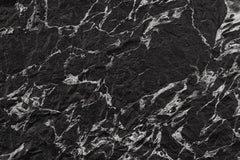 Veined Black Basalt flexible stone panel – dramatic deep black surface with dense silver-white fractured vein network and bold three-dimensional texture, close-up detail
